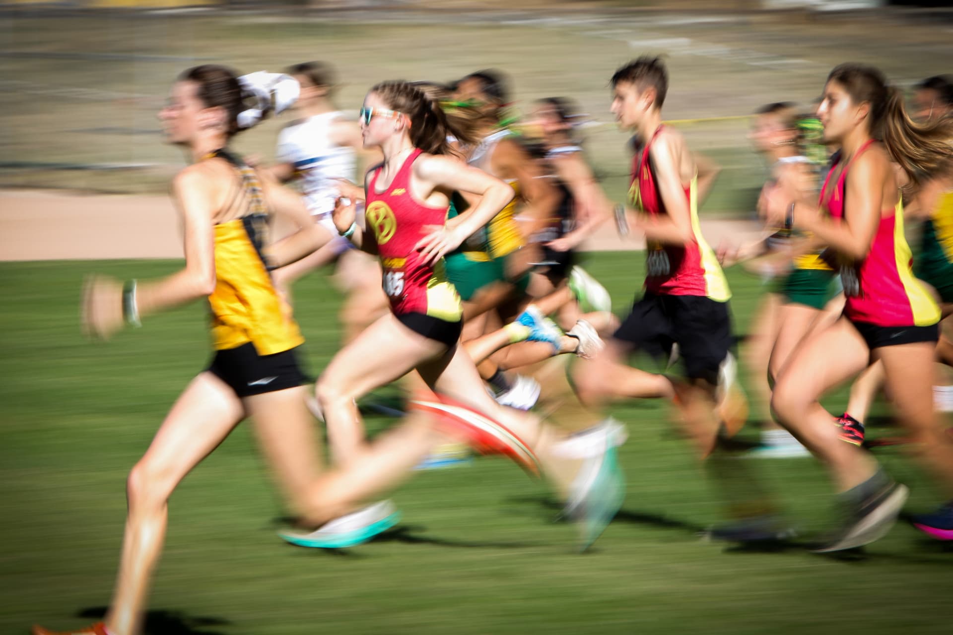 Motion-blurred cross country runners at a race finish